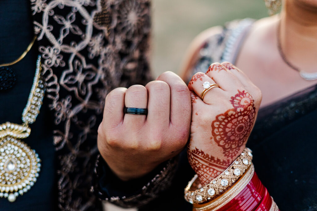 Bride and groom show off their rings and traditional henna at Lauxmont Farms.