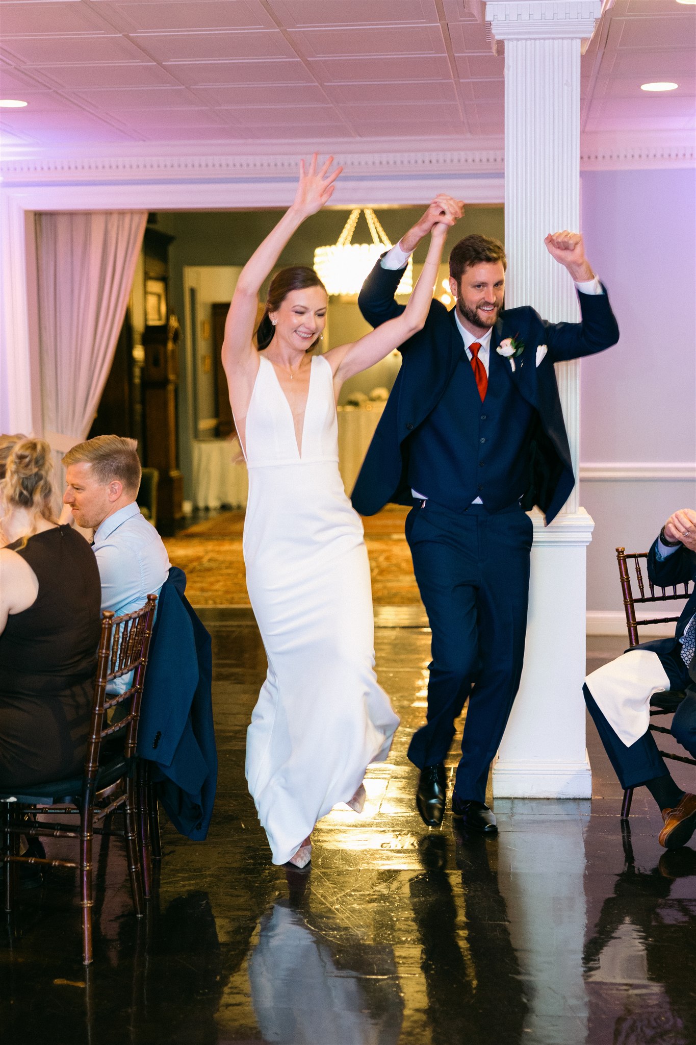 Bride and groom making their grand entrance at a wedding reception in Maryland, celebrating with guests during an elegant reception.